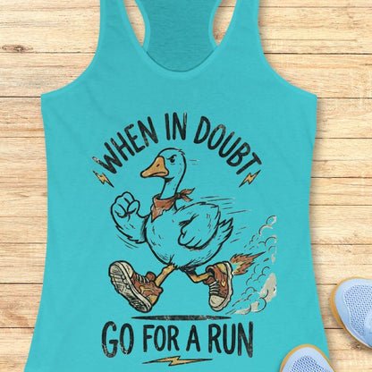 Turquoise tank top with a graphic of a duck and text 'When in doubt, go for a run' on a wooden surface