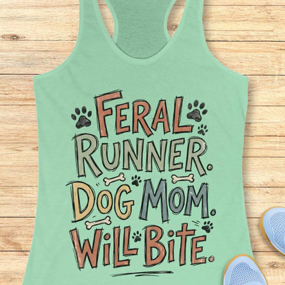 Light green tank top with text 'Feral Runner Dog Mom Will Bite' on a wooden surface.