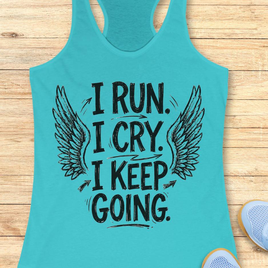 Turquoise tank top with motivational quote  "I run. I cry. I keep going." and wings on a wooden surface