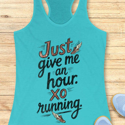 Turquoise tank top with motivational quote "just give me an hour. xo running."  on a wooden surface