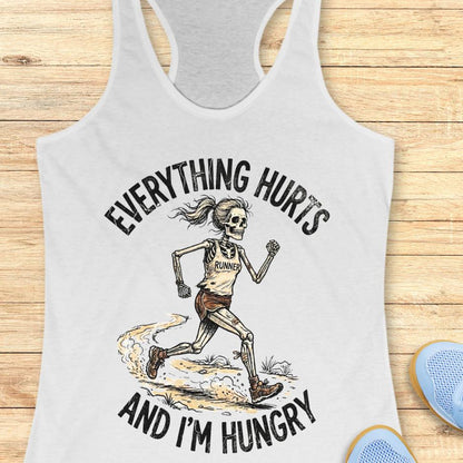 white graphic and text 'Everything hurts and I'm hungry' on a wooden surface.