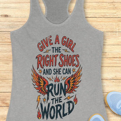 grey tank top with motivational quote "give a girl the right shoes and she can run the world" on a wooden surface