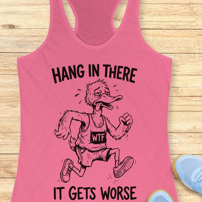 pink tank top with an image of a duck and text "hang in there it gets worse" on a wooden background