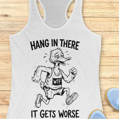 white tank top with an image of a duck and text "hang in there it gets worse" on a wooden background