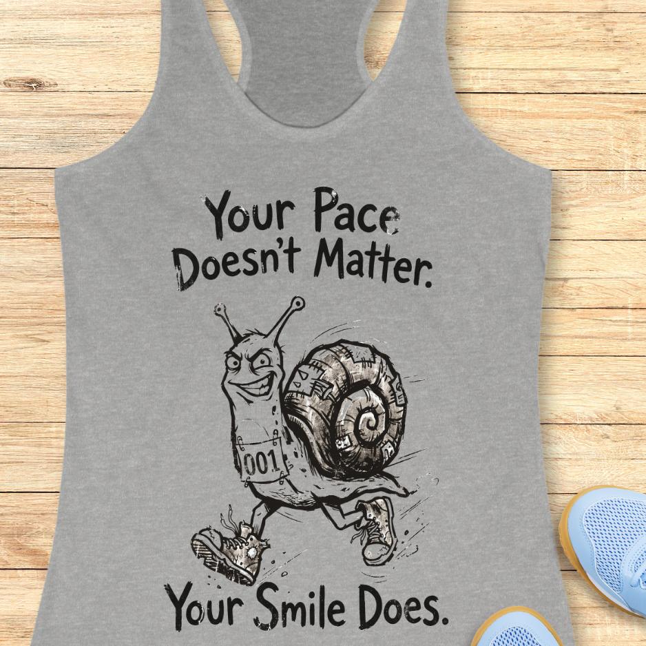grey tank top with an image of a running snail , smiling, and text - "your pace doesn't matter. Your smile does." on a wooden background