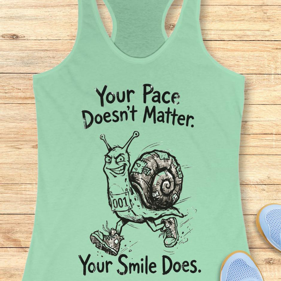 mint tank top with an image of a running snail , smiling, and text - "your pace doesn't matter. Your smile does." on a wooden background