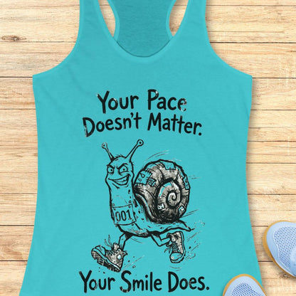 blue tank top with an image of a running snail , smiling, and text - "your pace doesn't matter. Your smile does." on a wooden background