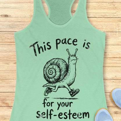 mint tank top with a runner snail and text - this pace is for your self esteem. on a wooden background