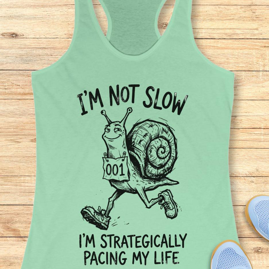 mint tank top with a running snail and text - I'm not slow I'm strategically pacing my life on a wooden background