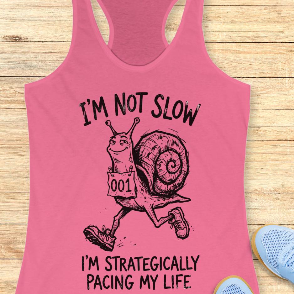 pink tank top with a running snail and text - I'm not slow I'm strategically pacing my life on a wooden background