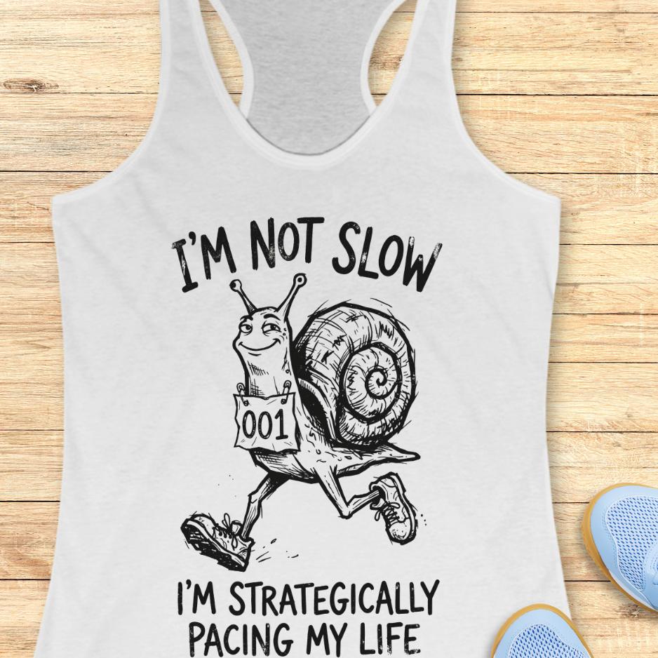 white tank top with a running snail and text - I'm not slow I'm strategically pacing my life on a wooden background