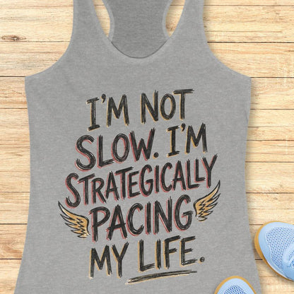 grey tank top with text - I'm not slow. I'm strategically pacing my life. on wooden background