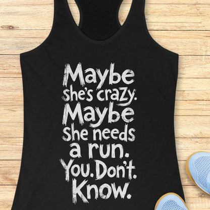 black tank top with text - maybe she's crazy. Maybe she needs a run. You. Don't. Know.  on a wooden background