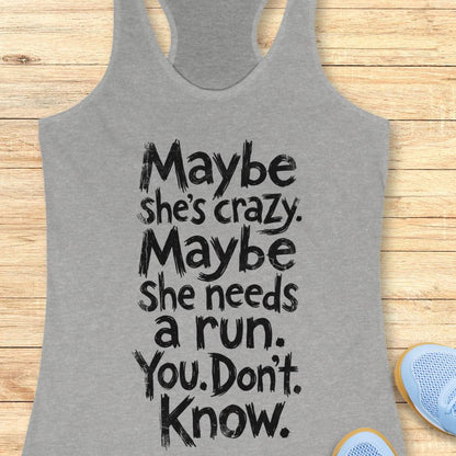 grey tank top with text - maybe she's crazy. Maybe she needs a run. You. Don't. Know.  on a wooden background