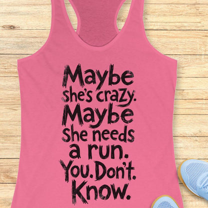 pink tank top with text - maybe she's crazy. Maybe she needs a run. You. Don't. Know.  on a wooden background