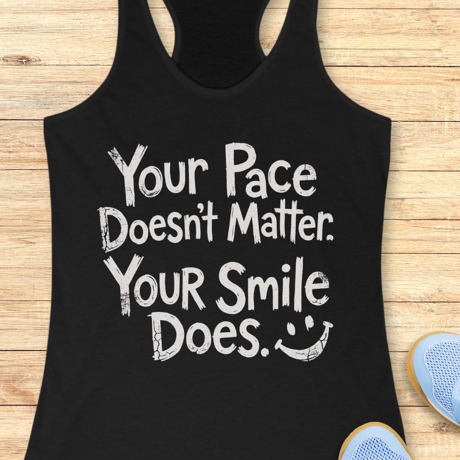 black tank top with the text - your pace doesn't matter. your smile does. on a wooden background