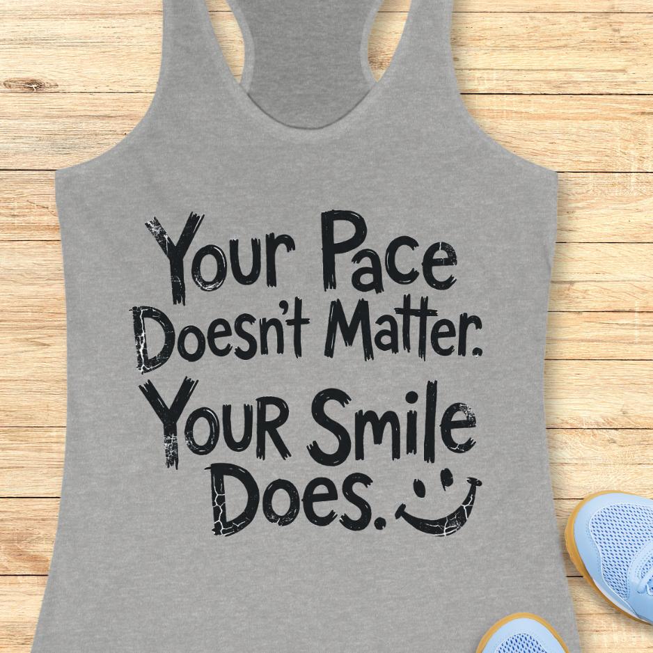 grey tank top with the text - your pace doesn't matter. your smile does. on a wooden background