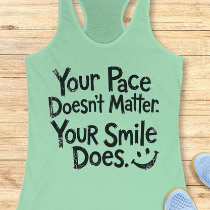 mint tank top with the text - your pace doesn't matter. your smile does. on a wooden background