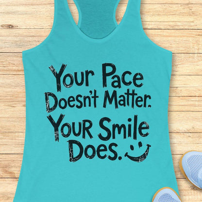 blue tank top with the text - your pace doesn't matter. your smile does. on a wooden background