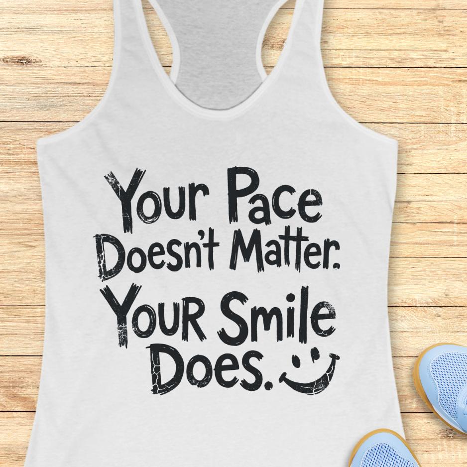 white tank top with the text - your pace doesn't matter. your smile does. on a wooden background