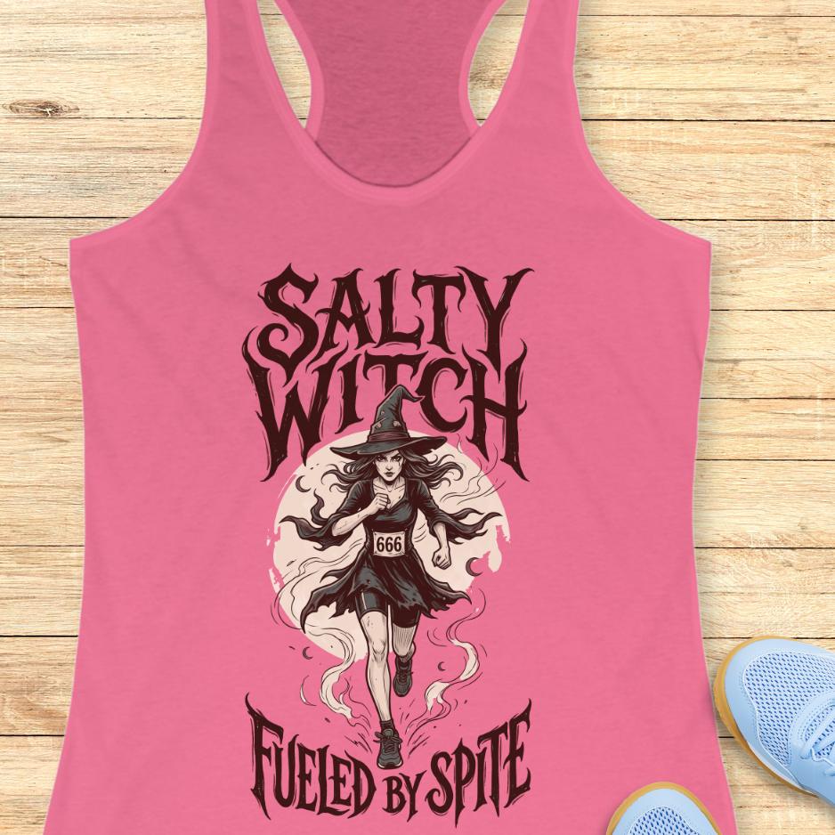 pink tank top with an image of a running witch and the text - salty witch. Fueled by spite. on a wooden background