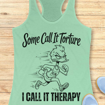 mint tank top with cartoon character and text - some call it torture. I call it therapy.  on a wooden surface