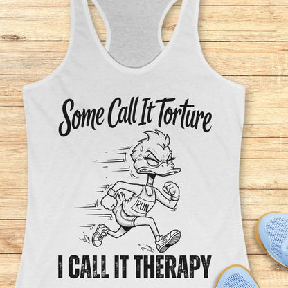 white tank top with cartoon character and text - some call it torture. I call it therapy.  on a wooden surface