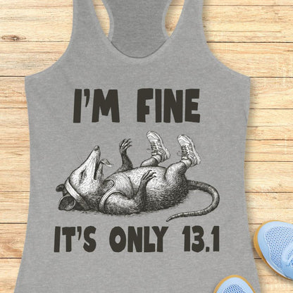 grey tank top with  a possum playing dead with running shoes and text - I'm fine it's only 13.1, with wooden background