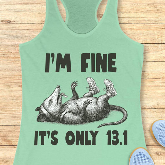 mint tank top with  a possum playing dead with running shoes and text - I'm fine it's only 13.1, with wooden background