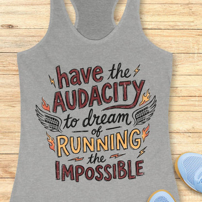grey tank top with the text - have the audacity to dream of running the impossible , on a wooden background