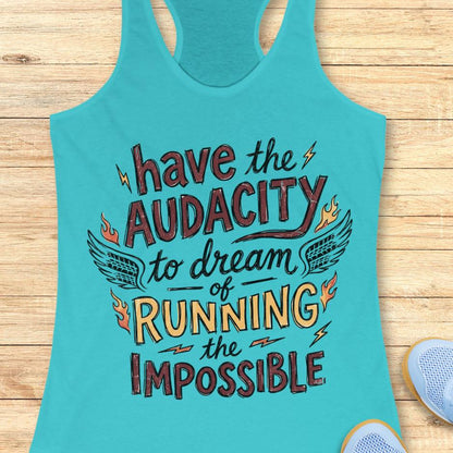 blue tank top with the text - have the audacity to dream of running the impossible , on a wooden background