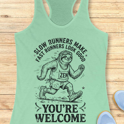 mint tank top with an image of a sloth runner and the text - slow runners make fast runners look good. you're welcome. on a wooden background