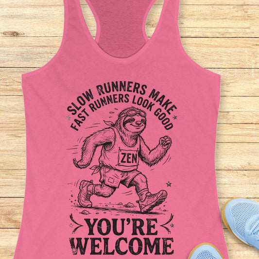 pink tank top with an image of a sloth runner and the text - slow runners make fast runners look good. you're welcome. on a wooden background