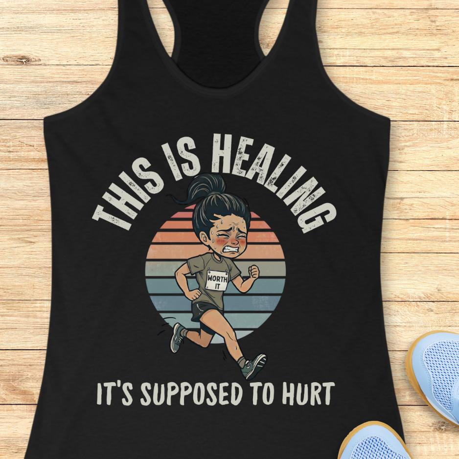 black tank top with an image of a woman running and a text - this is healing, it's supposed to hurt, on a wooden background