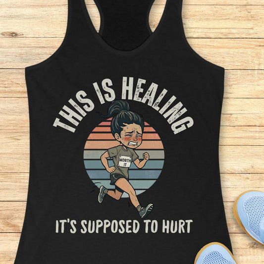 black tank top with an image of a woman running and a text - this is healing, it's supposed to hurt, on a wooden background