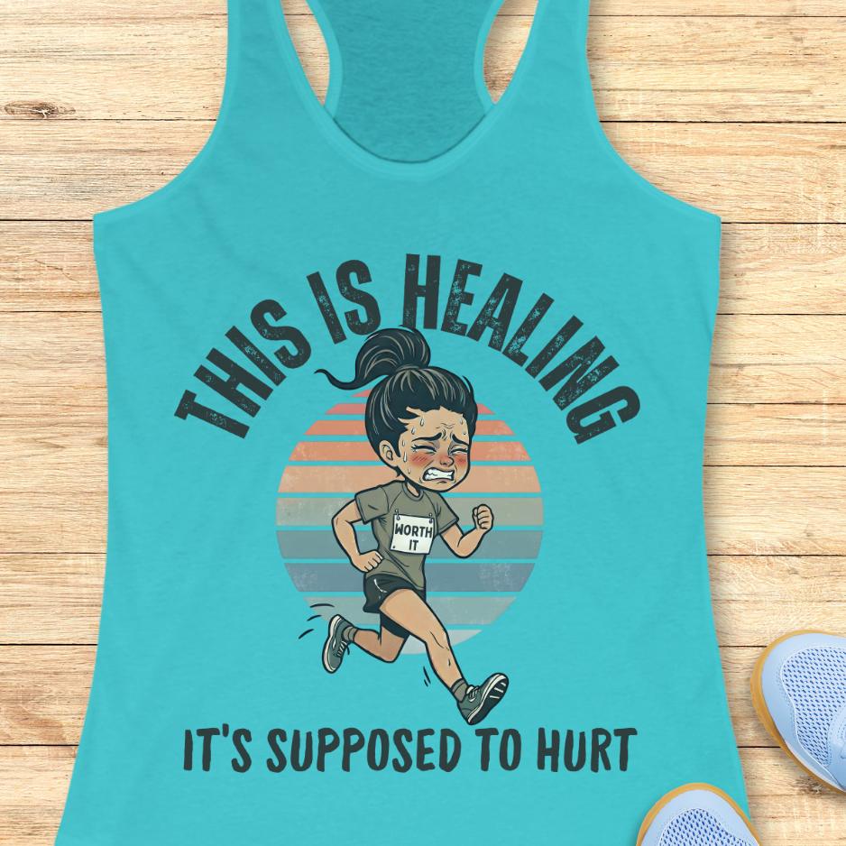 blue tank top with an image of a woman running and a text - this is healing, it's supposed to hurt, on a wooden background