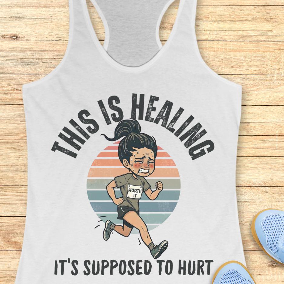 white tank top with an image of a woman running and a text - this is healing, it's supposed to hurt, on a wooden background