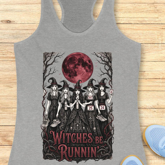 grey tank top with an image of 5 running witches , bloody moon and text - witches be runnin', on a wooden background