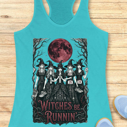 blue tank top with an image of 5 running witches , bloody moon and text - witches be runnin', on a wooden background