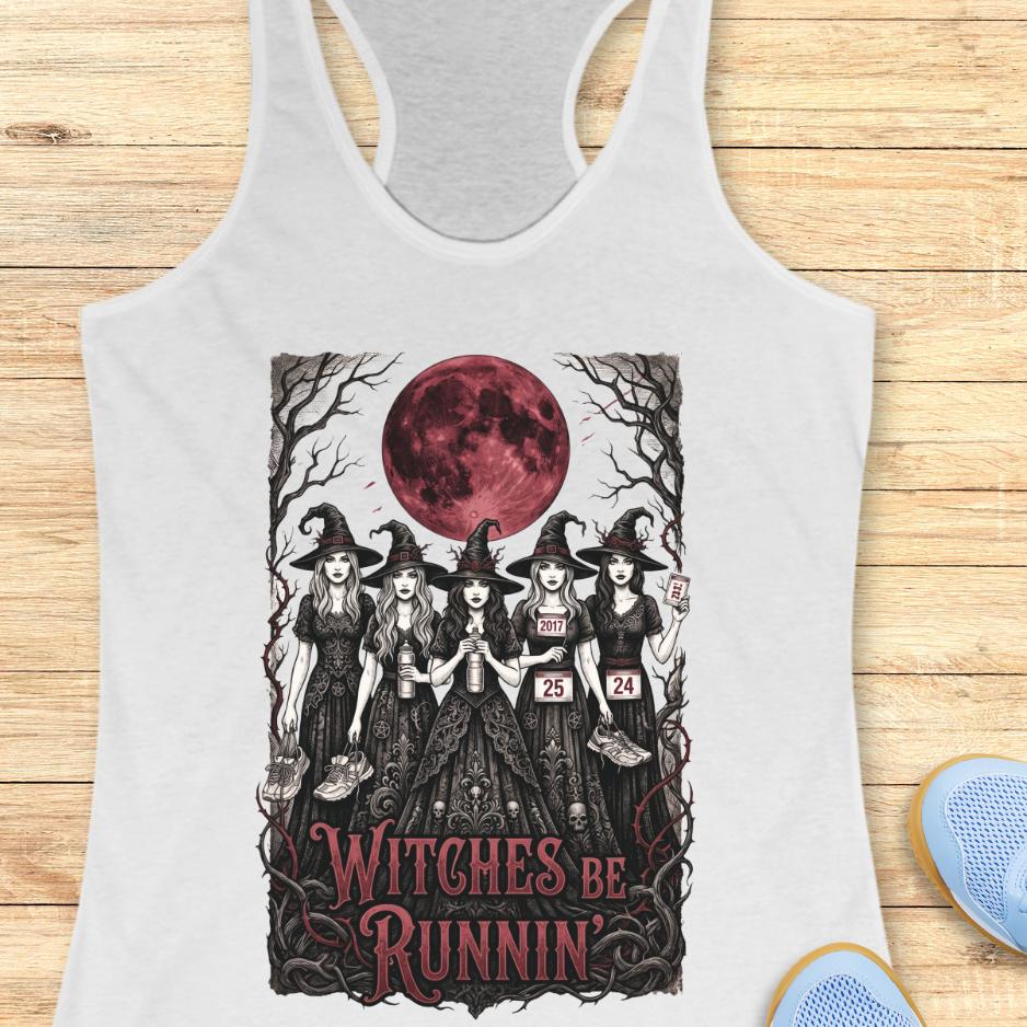 white tank top with an image of 5 running witches , bloody moon and text - witches be runnin', on a wooden background