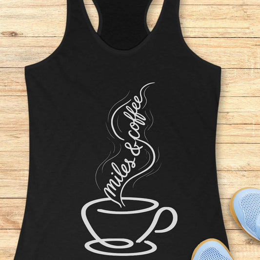 Black tank top with a white coffee cup design and text miles and coffee on a wooden surface.