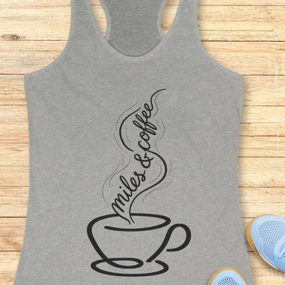 Gray tank top with a coffee cup and text  miles and coffee design on a wooden surface