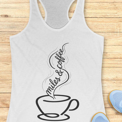 White tank top with a coffee cup and text miles and coffee design on a wooden surface