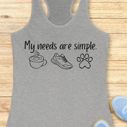 Gray tank top with text My needs are simple, and graphics on a wooden surface