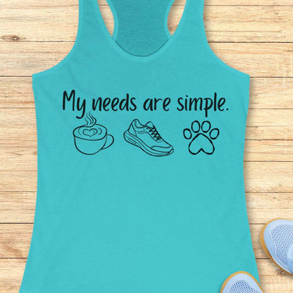 Turquoise tank top with text My needs are simple, and graphics on a wooden surface