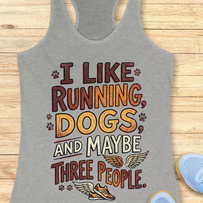 Gray tank top with text 'I like running, dogs, and maybe three people' on a wooden surface.
