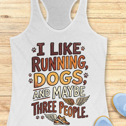 White tank top with text 'I like running, dogs, and maybe three people' on a wooden surface.