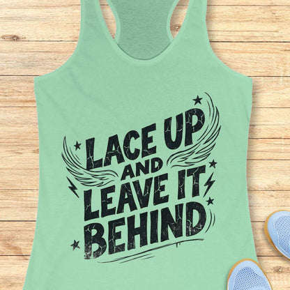 Mint green tank top with 'Lace Up and Leave It Behind' text on a wooden surface