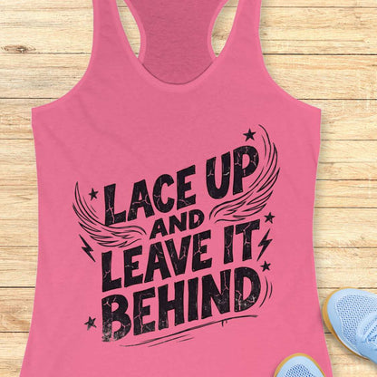 Pink tank top with 'Lace Up and Leave It Behind' text on a wooden surface