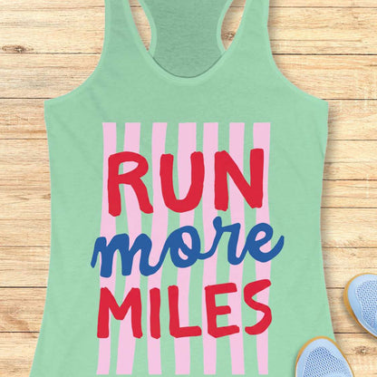 Green tank top with 'RUN more MILES' text on a wooden surface